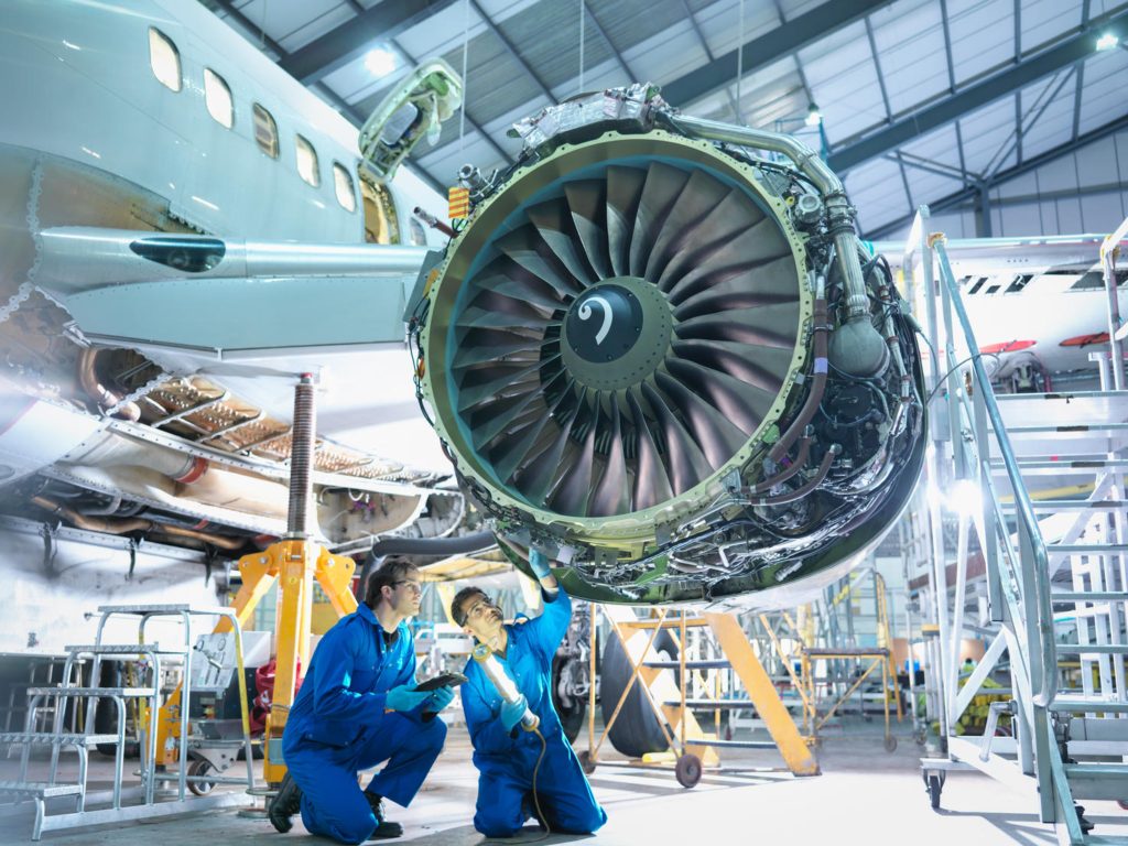 EFKNYK Aircraft engineers inspecting jet engine in aircraft maintenance factory